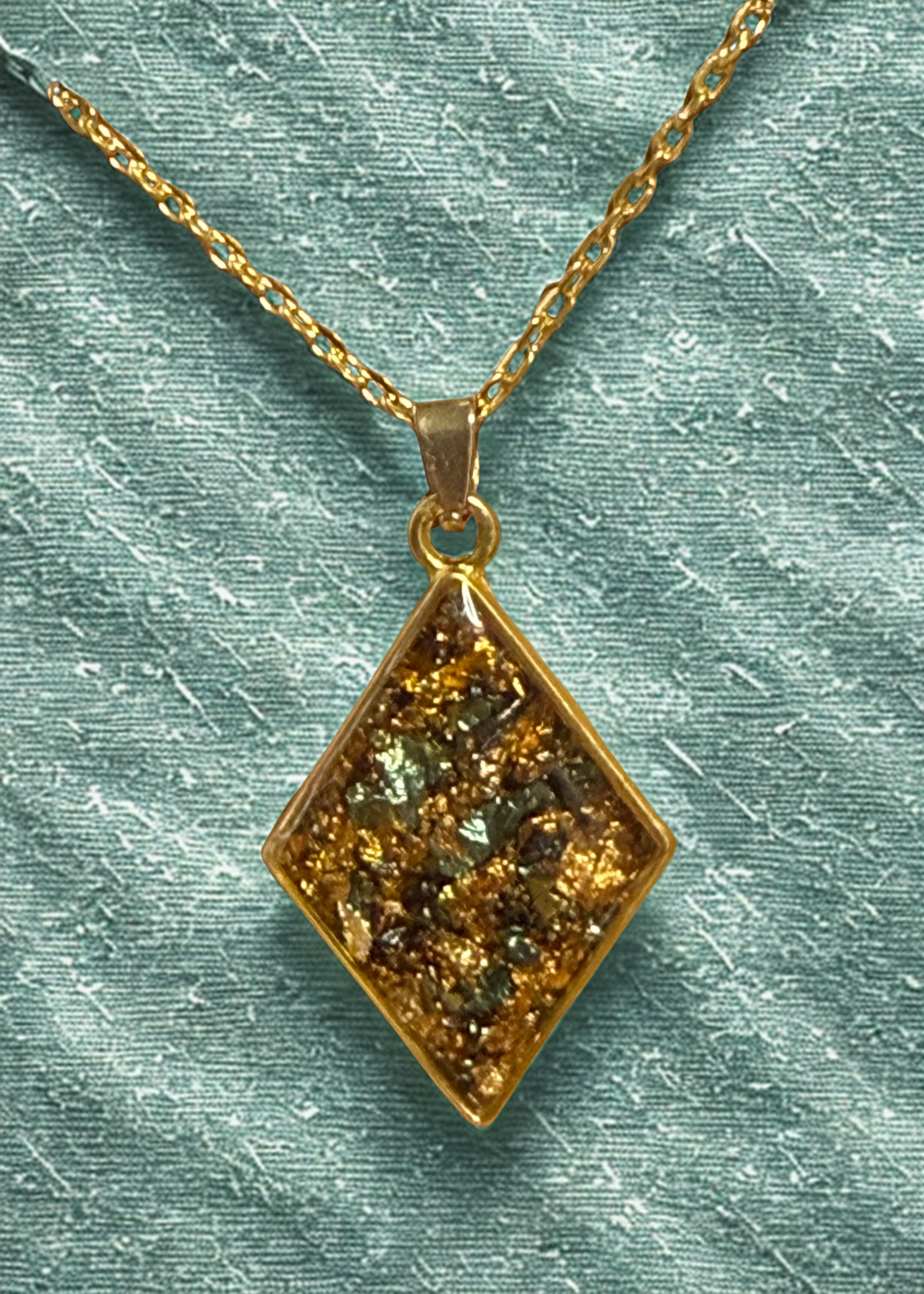 striking gold diamond-shaped bezel pendant necklace featuring delicate golden foil.